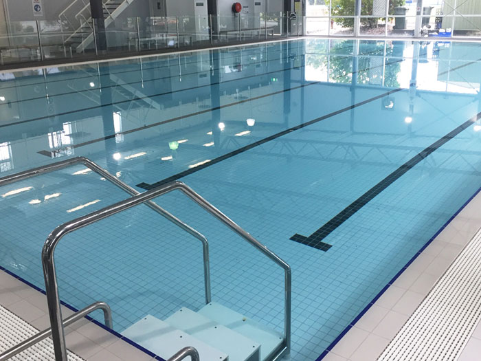 Click to return to the previous page Fully tiled indoor pool in CM115 White 58mm with CM120 Black used as lane marking tiles.